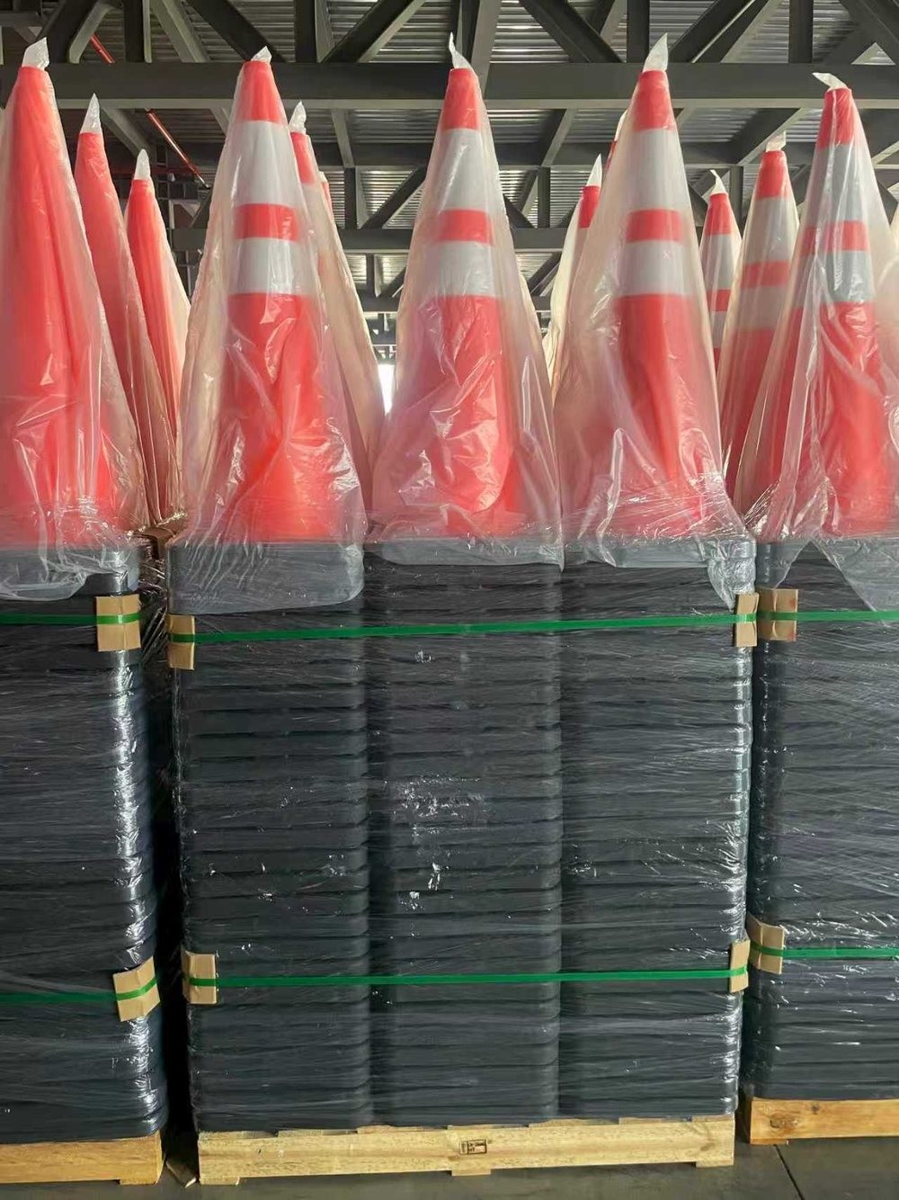 Wrapped traffic cones stacked on pallets in the warehouse